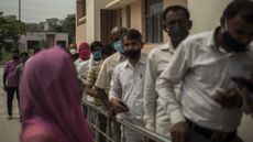 Patients queue for a vaccination in Noida, India