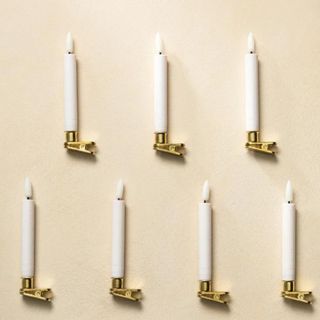 LED Candles with Brass Clips against a cream background.