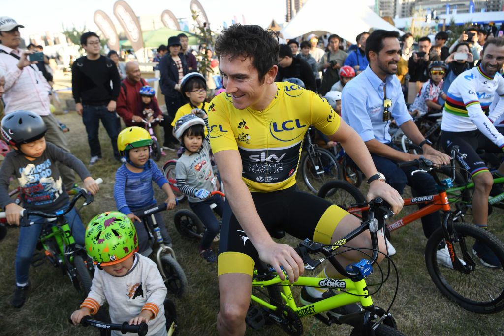 Geraint Thomas lines up with some local kids