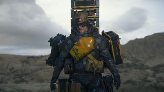 Death Stranding 2 stats: Sam carrying lots of cargo while walking towards the camera, wearing sunglasses.