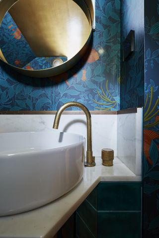 brass tap in a blue bathroom