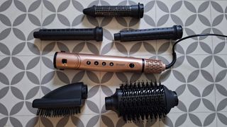 Revamp Dynamic Radiance Pro hair styler with all its attachments around it