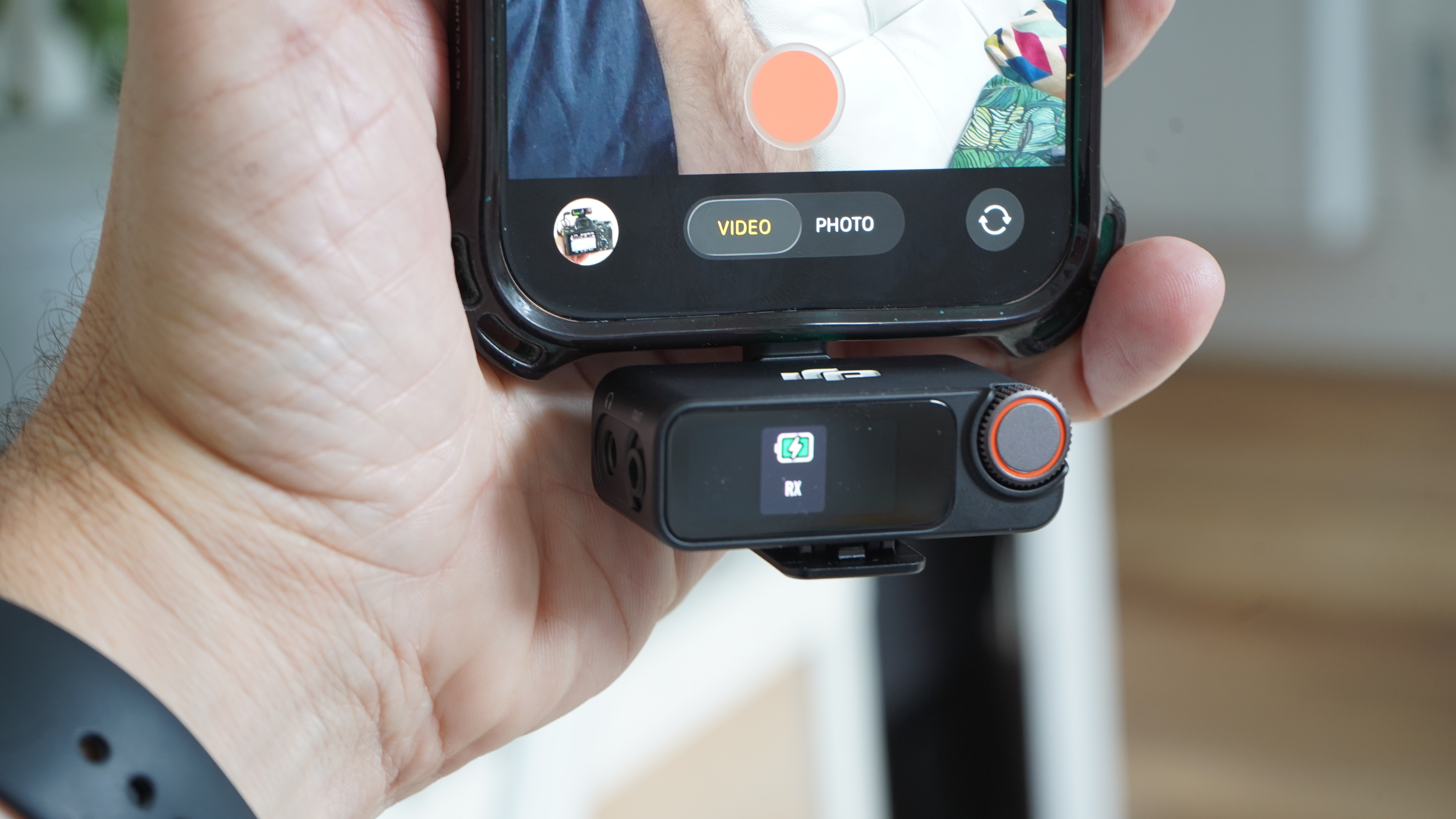 RX of DJI Mic 3 in hand on iPhone 16