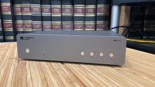 Cambridge Audio MXN10 on a wooden rack with books in background