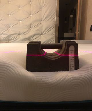 Brook & Wilde mattress weight test – a weight placed on the mattress sinking down