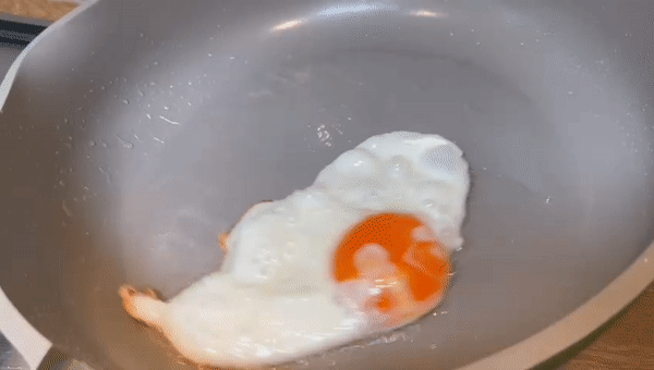 fried egg sliding around in a nonstick pan