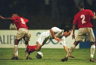 Ali Karimi of Iran takes a tumble during the FIFA 2002 World Cup Qualifier between Bahrain and Iran played at the National Stadium in Manama, Bahrain. Bahrain won the match 3 - 1.
