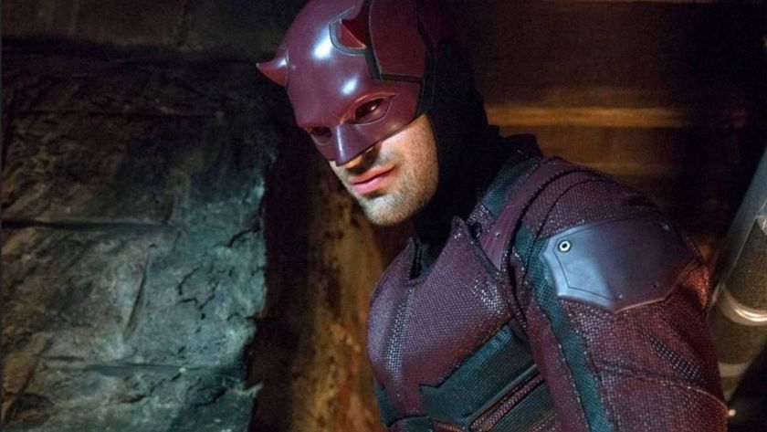 A costumed Matt Murdock smiles at someone off-camera in Netflix&#039;s Daredevil TV show