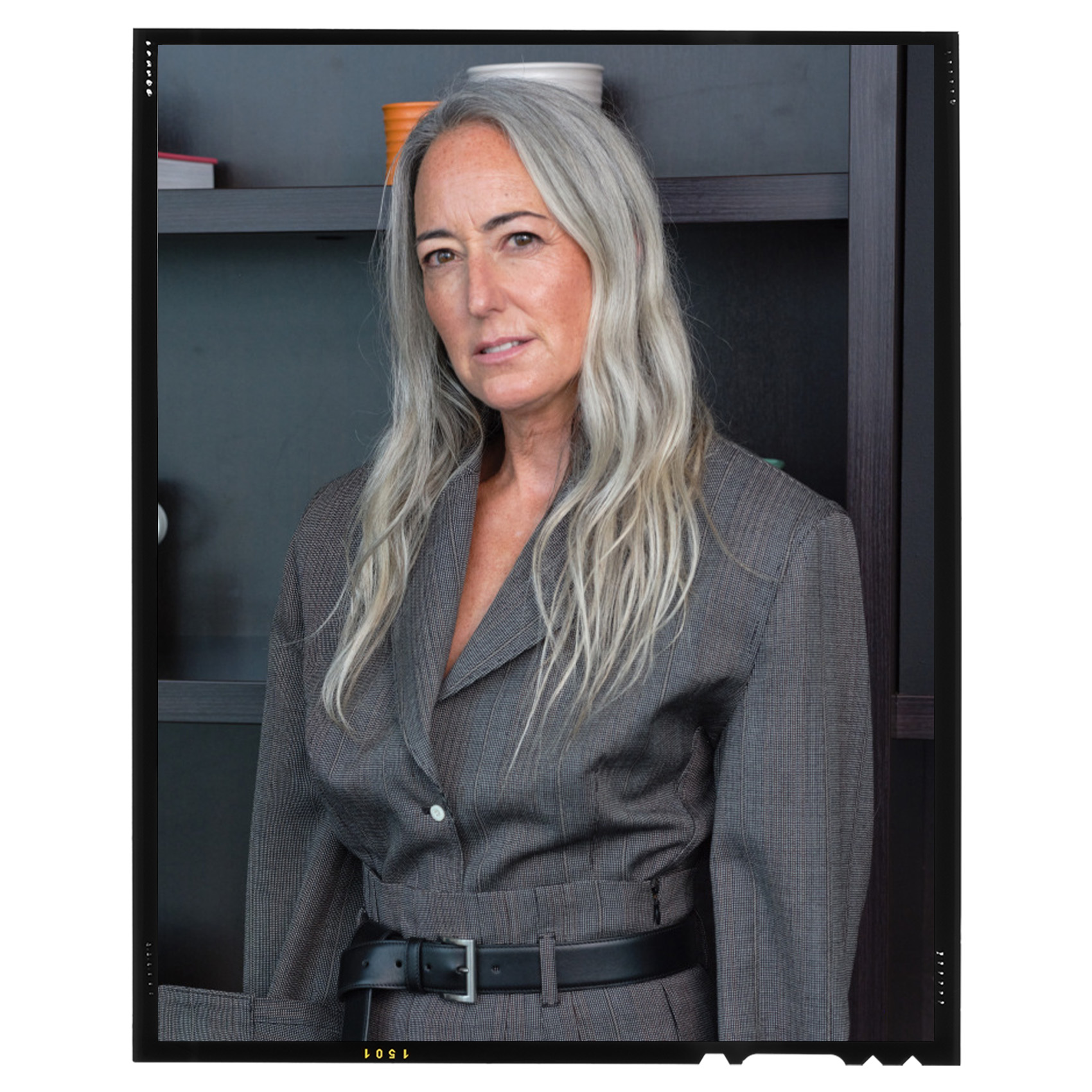 portrait of Brigitte Chartrand wearing a grey blazer, black leather belt, and gray skirt