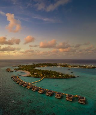 Patina Maldives cabins standing in water raised on stilts