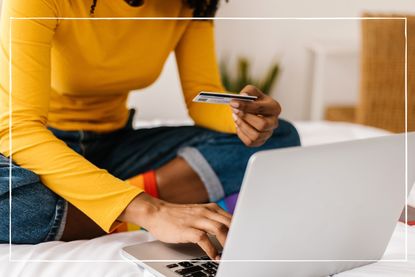 close up of woman using credit card to shop online