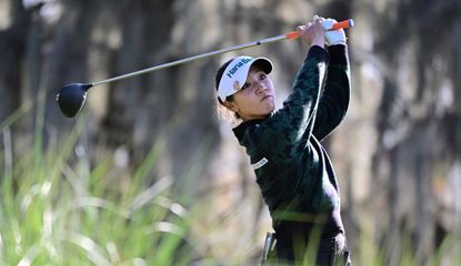 Lydia Ko strikes her tee shot with a driver and watches the flight