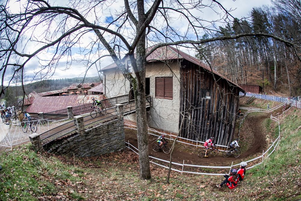 Riders go through and under the Antler Hill barn along the course