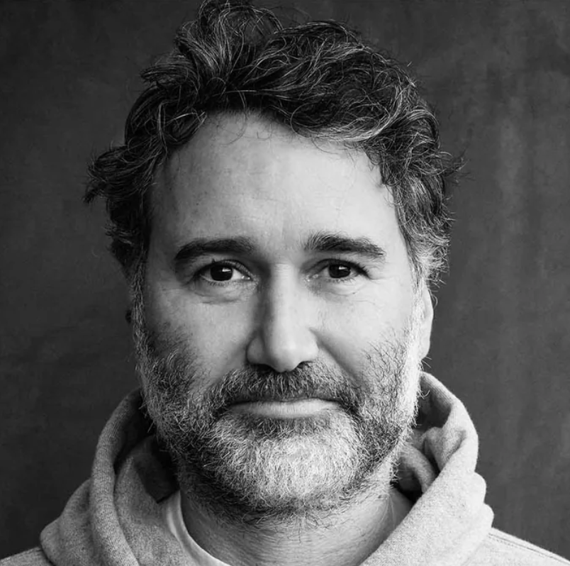 a black and white photo of a white man with a beard