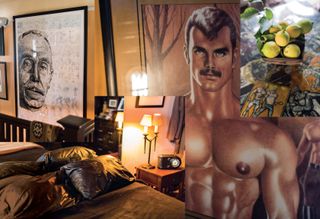 Montage of images, upper left a sketch black and white portrait of Tom, framed in black over a headboard, Bottom left: double bed with black leather pillows, side table with lit lamp and black clock, black dressing table in the backdrop, Upper right: square shaped wooden bowl of lemons on a erotically decorated table top, Bottom right: Painting of a topless muscular male