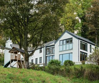 White stone cottage with modern extension in Welsh countryside