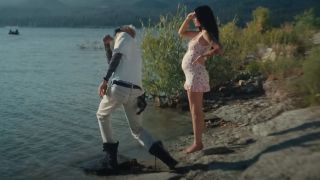 Megan Fox wears a baby bump as Machine Gun Kelly skips rocks in MGK and Jelly Roll's music video for "Lonely Road."