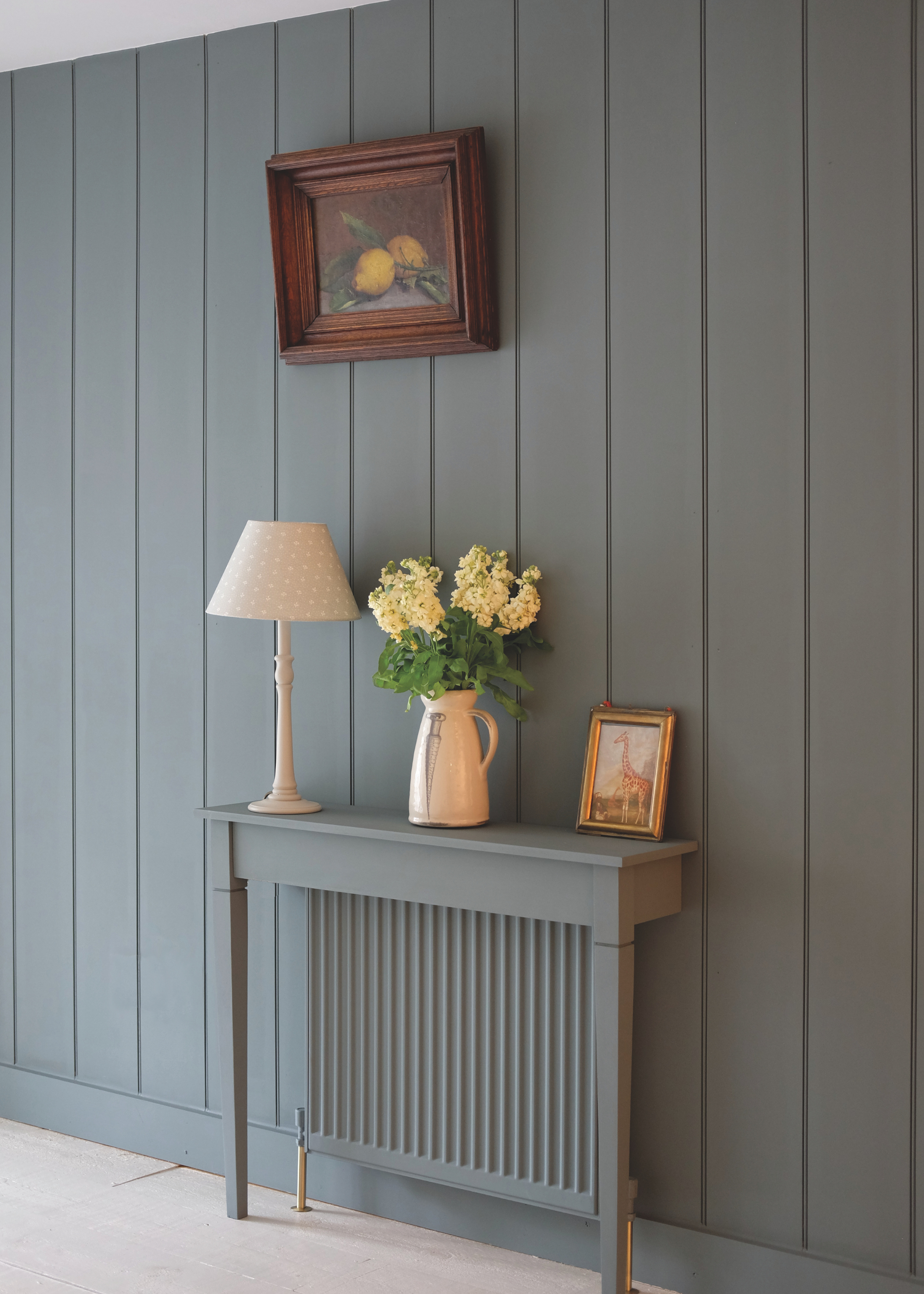 a radiator table painted same color as radiator and panelled wall