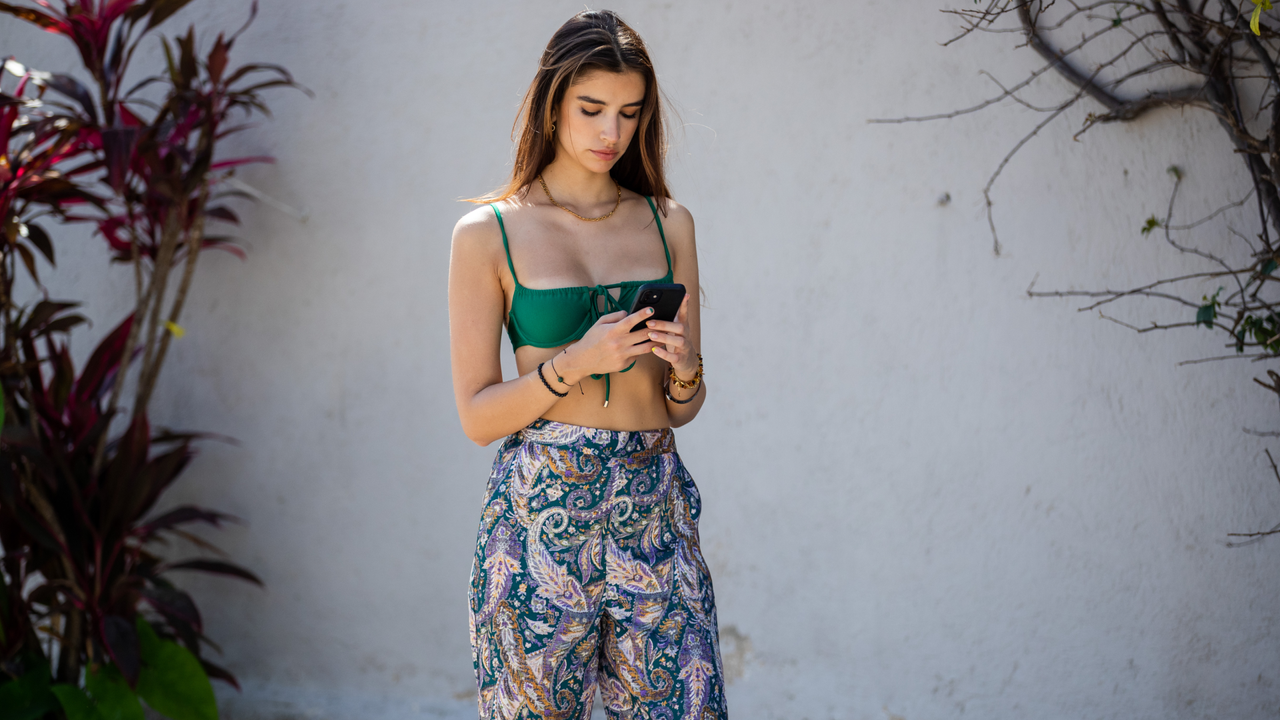 Alexandra Nicole is seen wearing green bikini top Janthee Berlin and pants with floral print Chinti on April 07, 2021 in Tulum, Mexico.