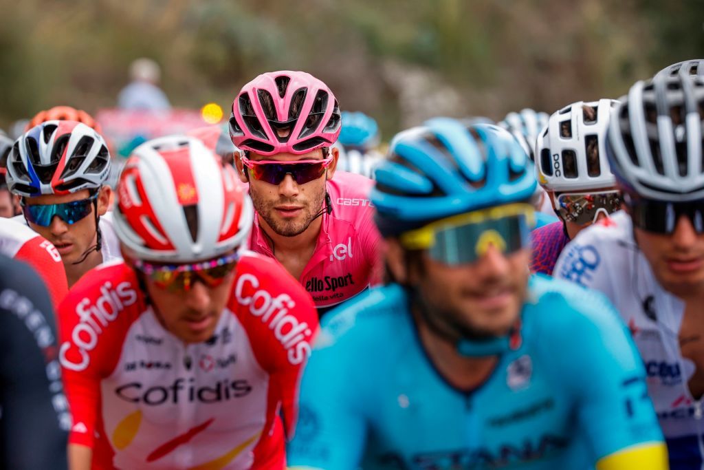 Overall leader Team Ineos rider Italys Filippo Ganna Rear CL wearing the pink jersey rides in the pack on October 5 2020 during the 3rd stage of the Giro dItalia 2020 cycling race a 150kilometer route between Enna and volcano Etna LinguaglossaPiano Provenzana Sicily Photo by Luca Bettini AFP Photo by LUCA BETTINIAFP via Getty Images