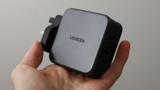 Ugreen Nexode 140W charger held in a hand