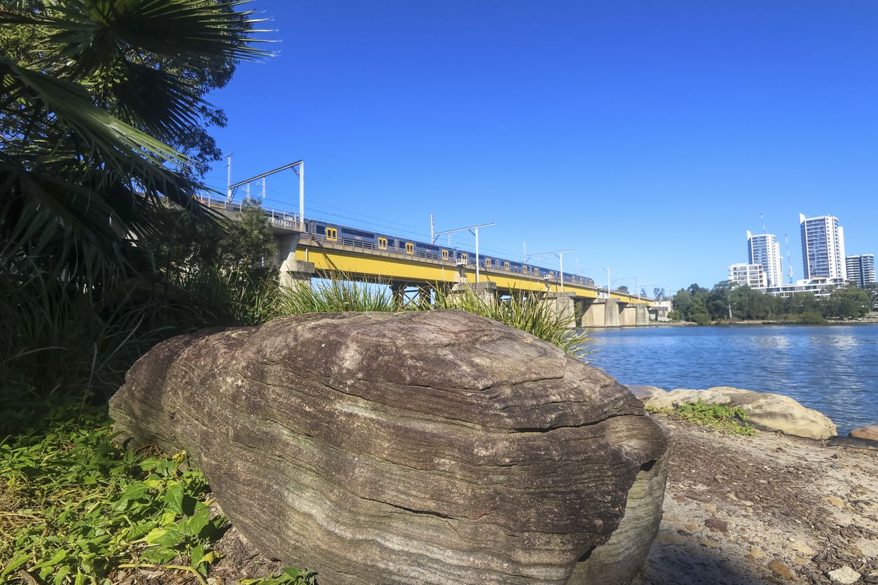 A waterfront and bridge in bright sunny weather