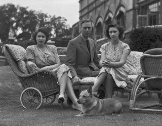 King George VI with his daughters Princess Elizabeth and Princess Margaret in the grounds of Windsor Castle in Windsor, England on July 08, 1946