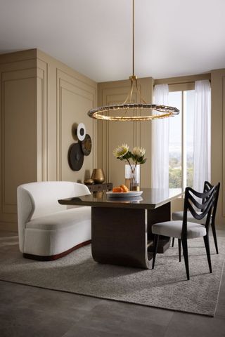 white curved dining sofa and chandelier pendant by Arteriors