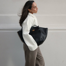 Ingrid in a white blouse and brown jeans