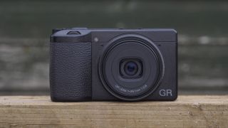 The Ricoh GR IIIx camera on a wooden table