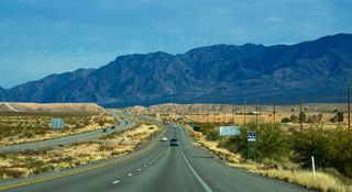 A road leads to mountains through the desert in Mesquite, Nevada.