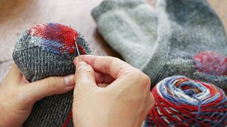 Person darning a sock