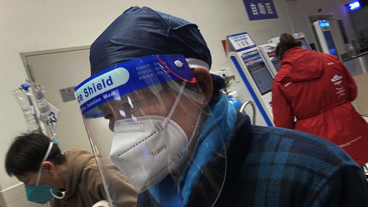 Somebody wearing a PPE mask in a Chinese hospital