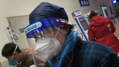 Somebody wearing a PPE mask in a Chinese hospital