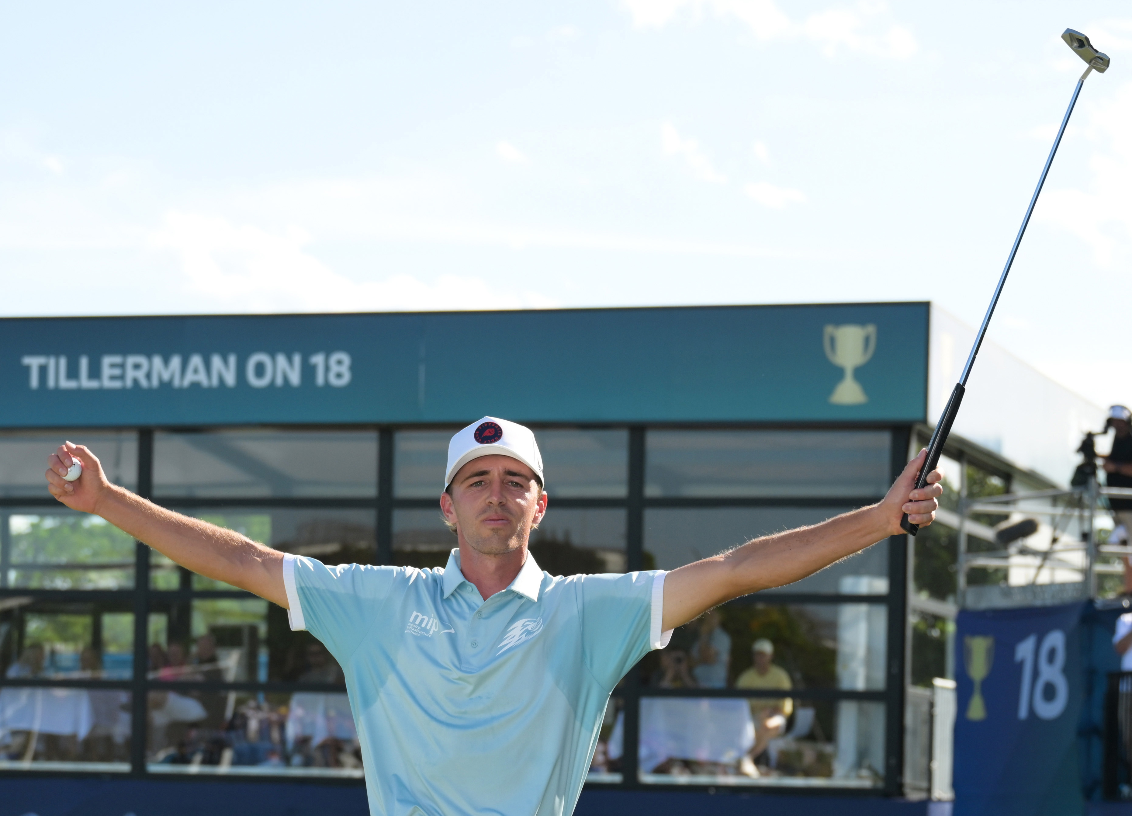David Puig raises his putter in the air