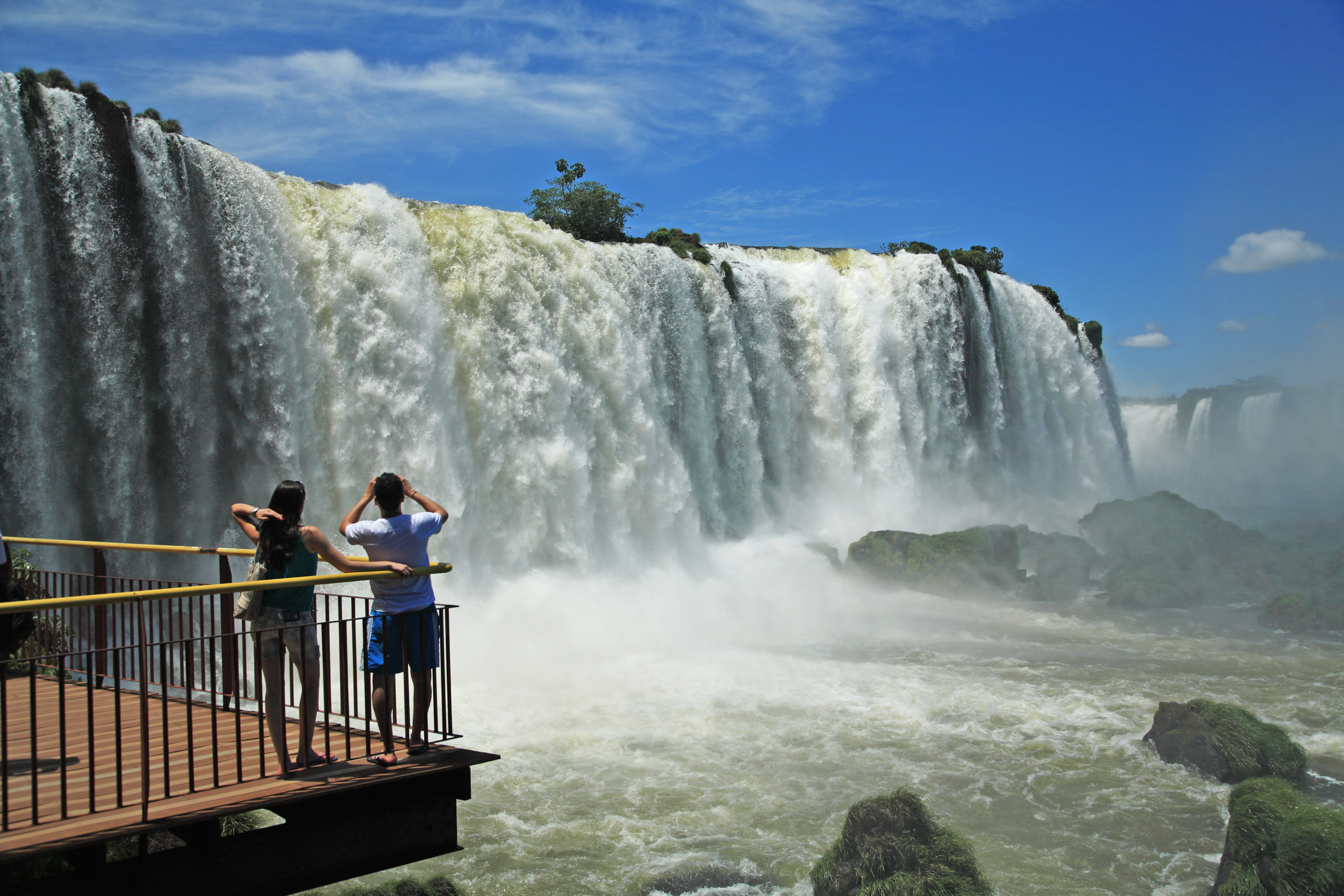 People look at Iguazu Falls from a viewing platform