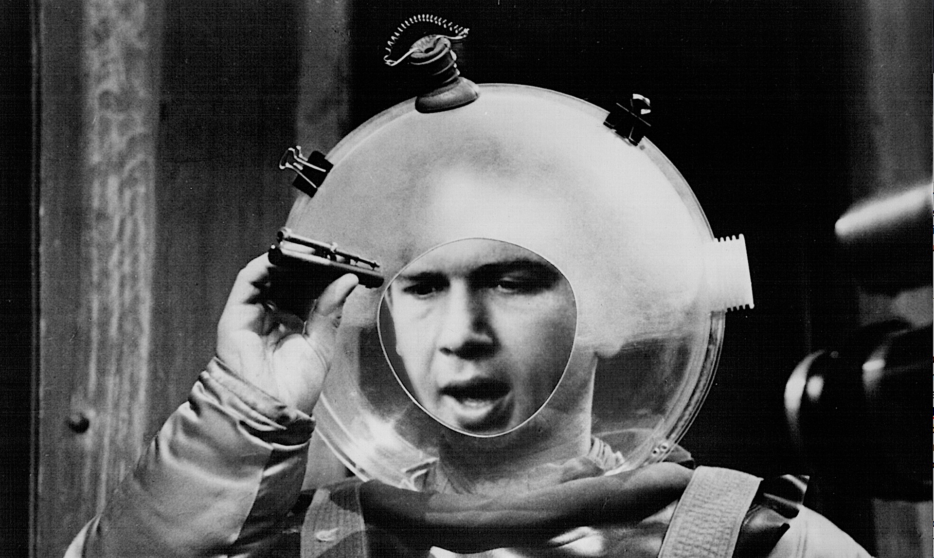 A man in a giant sci-fi bubble helmet