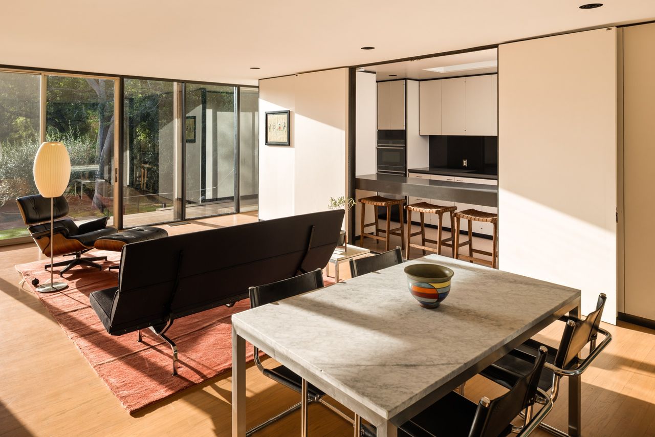 Sliding panels conceal the kitchen from the den