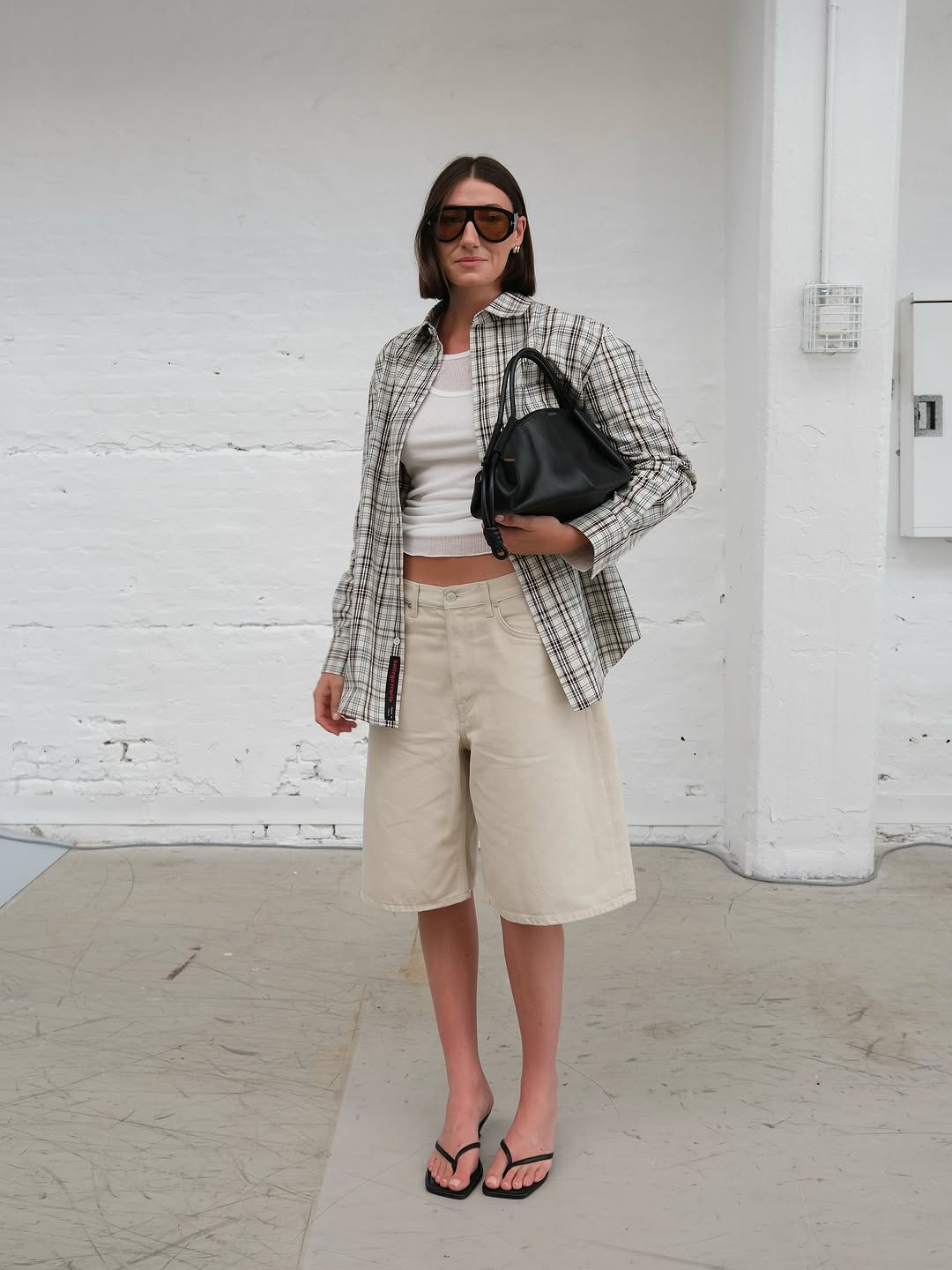 Woman wearing plaid jacket trend fall 2025.