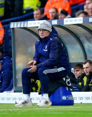 Leeds manager Marcelo Bielsa sits near the sideline during a Premier League match