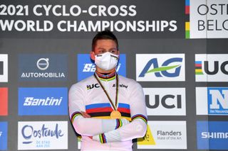 Mathieu van der Poel, winner of the elite men's UCI Cyclo-cross World Championship in Belgium in 2021, wears a mask to receive his gold medal