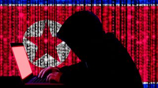 Abstract image showing a cyber criminal silhouetted against a North Korean flag