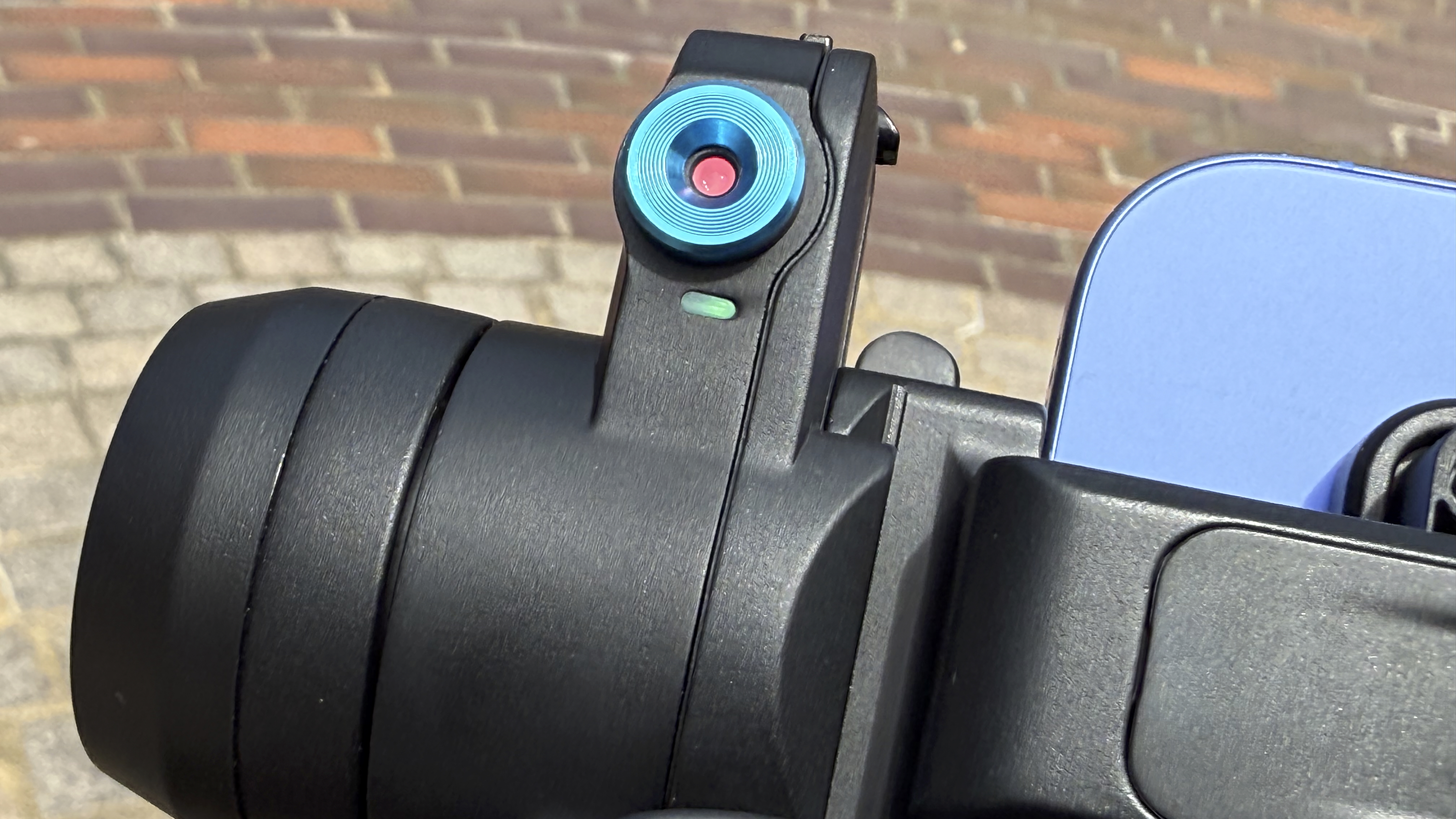 Close up of the AI-sensor built into the body of the Scorp Mini 3 Pro. A green light below the red sensor indicates that the gimbal is in tracking mode