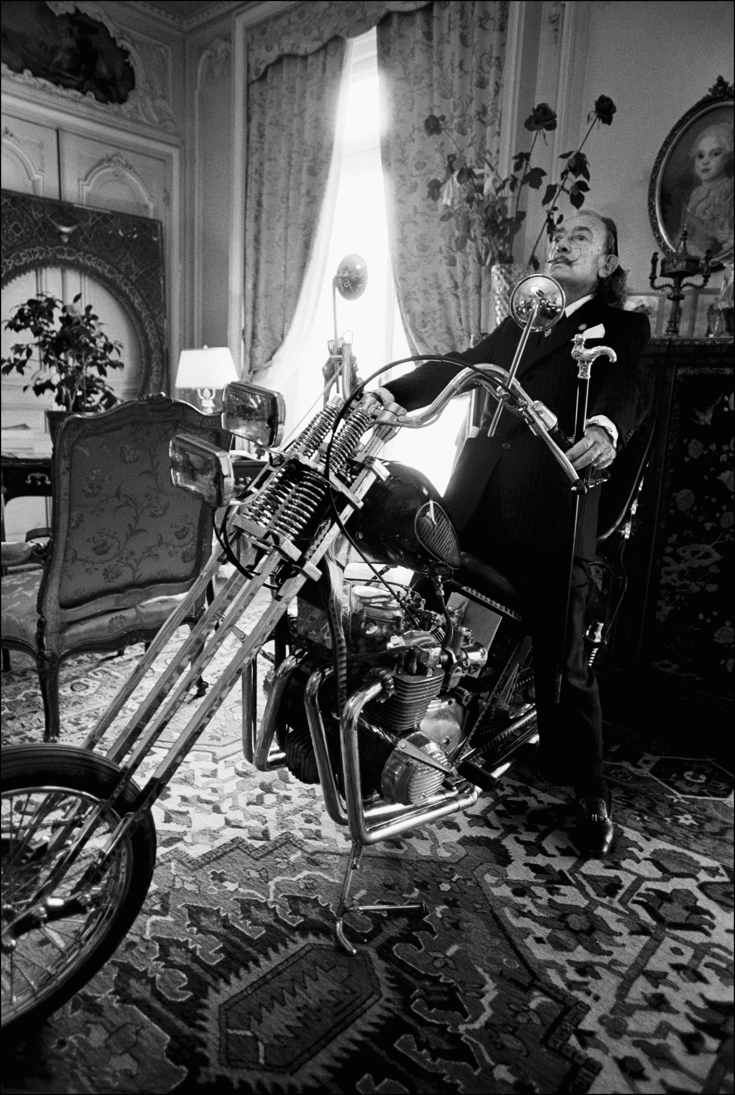 Salvador Dali poses on a Harley Davidson motorbike at the Le Meurice Hotel
