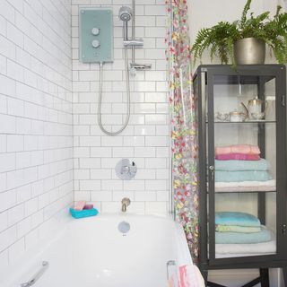 bathroom with white tiles wall and bathtub