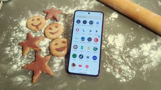 The Moto G84 looking festive amongst some baked goods