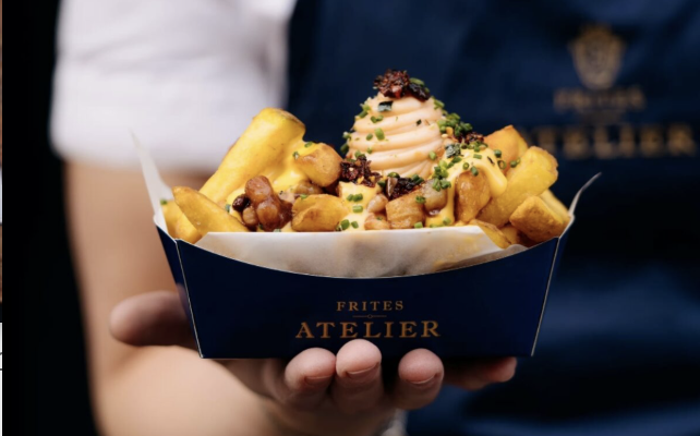an image of the fries behind held by one of the chefs