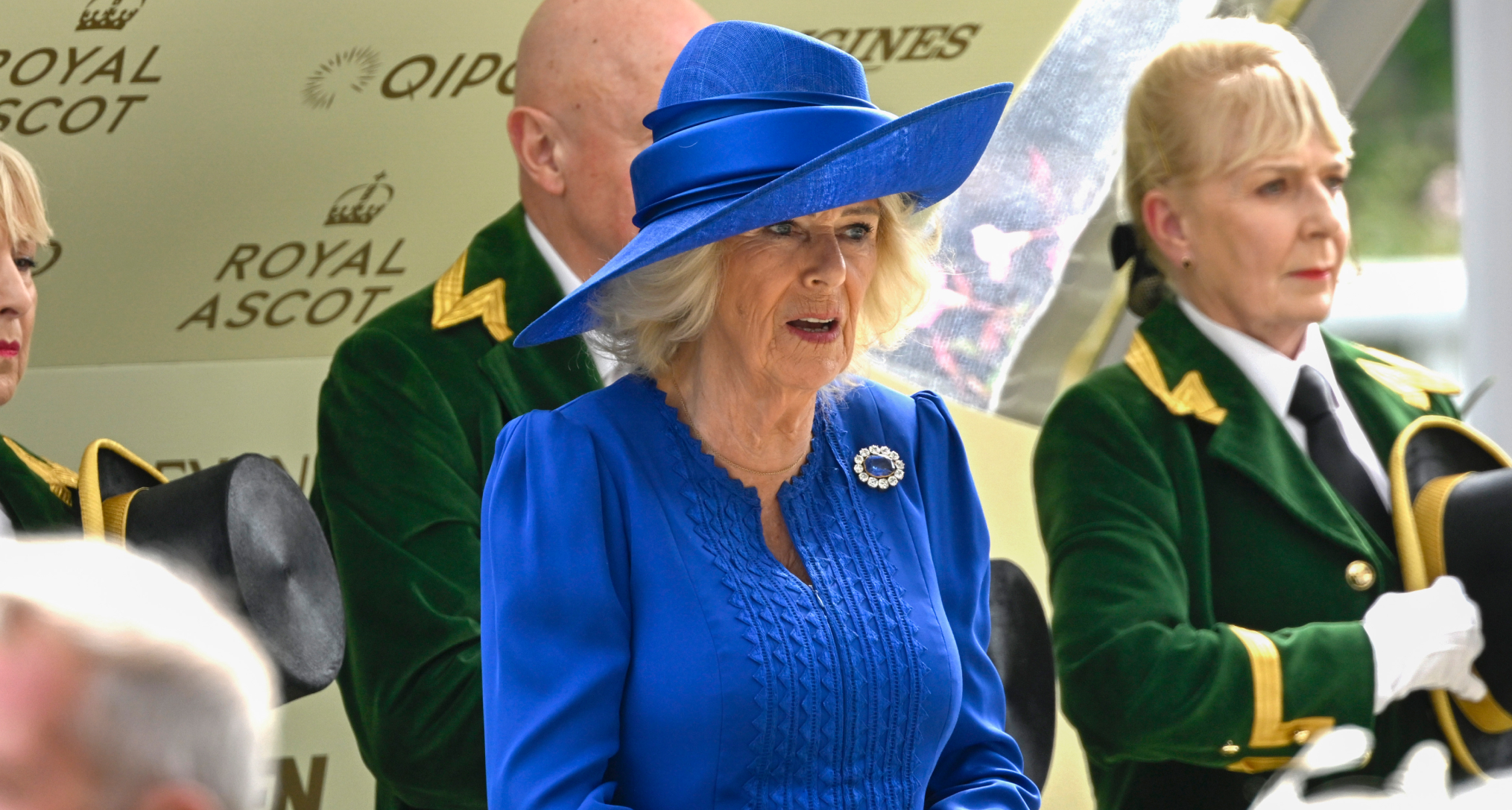 Queen Camilla in a blue dress and hat at Royal Ascot