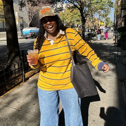 Tariro Makoni wearing a yellow rugby shirt and jeans in New York City