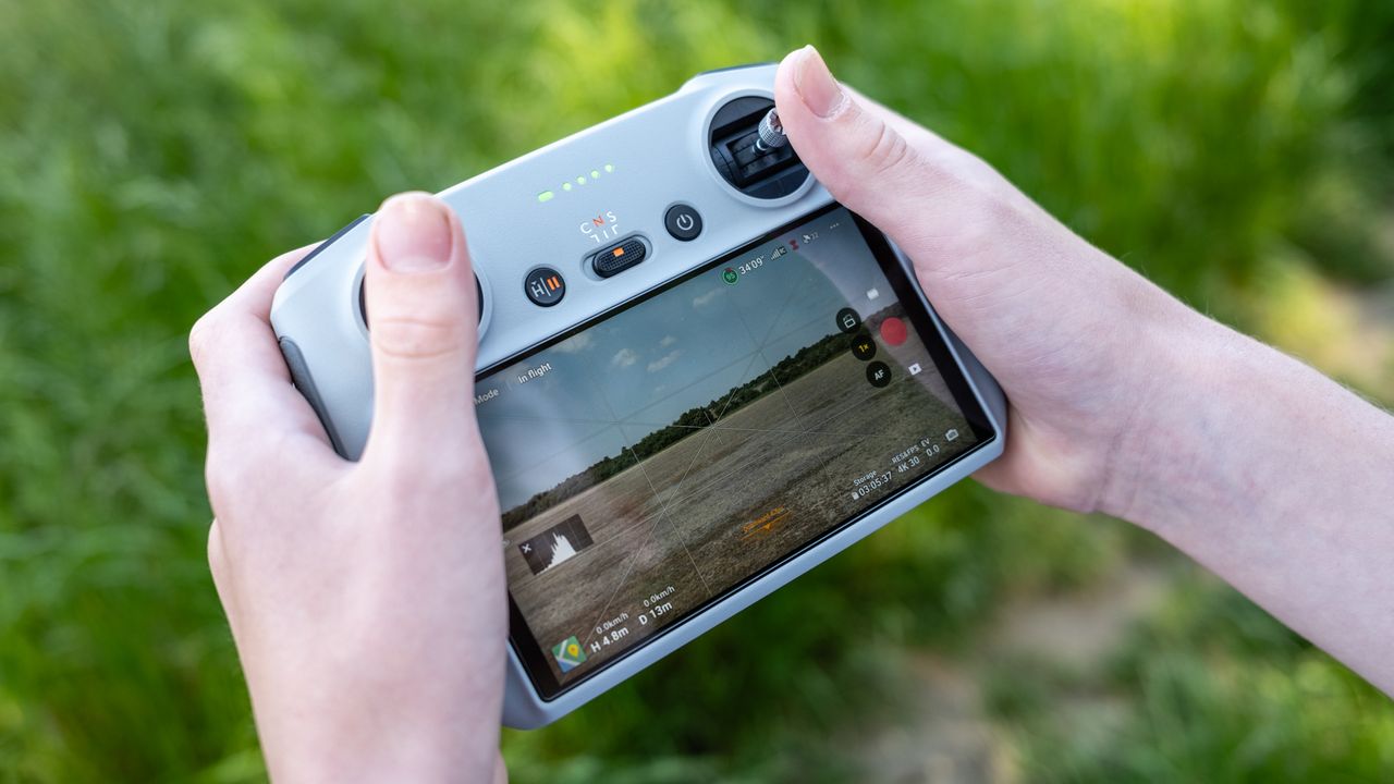 Hands holding a DJI RC Smart Controller